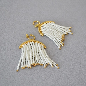 Detail of bohemian gold semi-circle earrings with white seed bead tassels and 925 silver needles