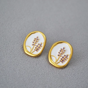 Vintage lavender enamel oval stud earrings in gold-plated brass on a grey background