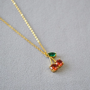 Détail du collier pendentif cerise avec cristaux rouges et chaîne plaquée or fin