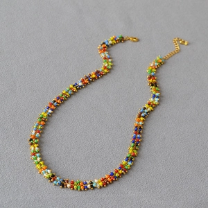 Detail of colorful bohemian beaded necklace with golden lobster clasp and extension chain