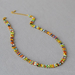 Detail of bohemian handmade beaded necklace with colorful beads and gold Lobster clasp