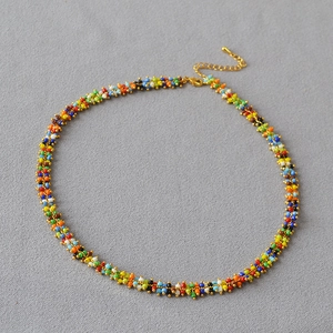 Detail of colorful Bohemian seed bead necklace with gold lobster clasp and extension chain