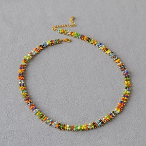 Detail of bohemian colorful seed bead necklace with gold clasp and extender chain
