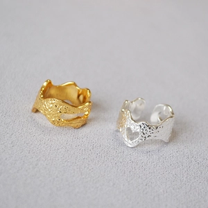 Detailed macro view of gold and silver hammered rings with heart-shaped cutouts