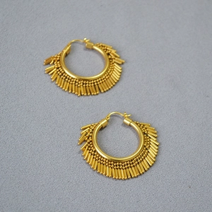Detailed view of gold plated brass hoop earrings with radiating metal fringe tassels
