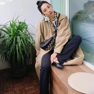 Chic black onyx earrings styled with a khaki trench coat and patterned blouse for autumn