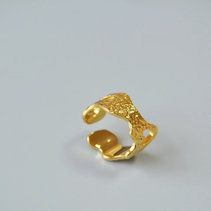 Macro shot of 18K gold plated brass ring with unique hammer texture and lava finish