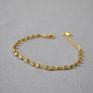 Detailed view of adjustable gold-plated brass bracelet featuring faceted laser-cut beads