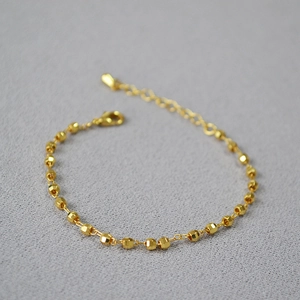 Detail of faceted gold-plated soccer beads bracelet with adjustable lobster clasp