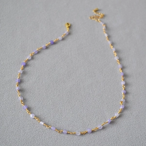 Detail of lavender crystal bead necklace with gold wire wrap and lobster claw clasp