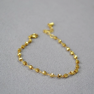 Minimalist faceted gold bead bracelet with adjustable chain and lobster clasp closure