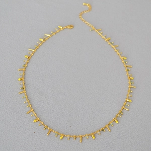 Minimalist gold chain necklace with delicate yellow green beads and bar pendants