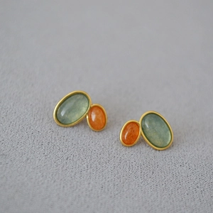 Vintage gold plated earrings featuring oval teal and orange natural stone inlays