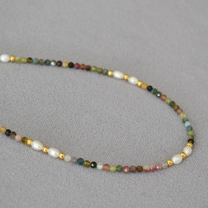 Detail of multi-color tourmaline faceted beads and white freshwater rice pearls necklace