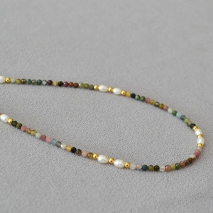 Macro detail of French vintage necklace with multi-colored tourmaline and freshwater pearls