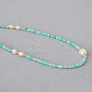 Detailed macro view of green amazonite beads with fresh water pearls on a necklace