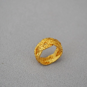 Detailed view of the vintage hollow braided texture and gold-plated twist design on the ring