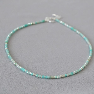 Detailed close-up of Amazonite beaded necklace with silver spacers and metal clasp