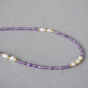 Close-up of natural lavender amethyst and white freshwater pearl necklace detail