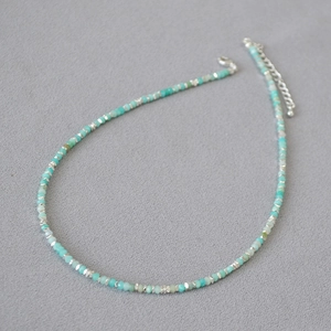 Detail of Amazonite beaded necklace with faceted light blue stones and silver accents