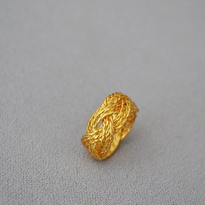 Detailed view of vintage gold plated brass ring with intricate woven braided pattern design
