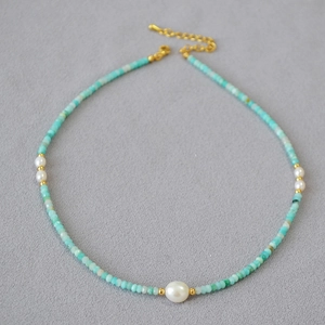 Detailed macro view of amazonite beaded necklace with freshwater pearls and gold clasp