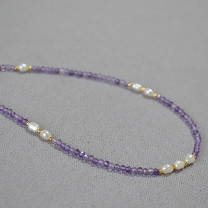 Detailed view of faceted lavender amethyst beads and freshwater pearls on a slim necklace