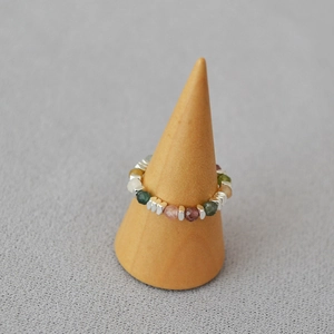 Detail of beaded elastic ring with colorful natural gemstones and silver hex spacers