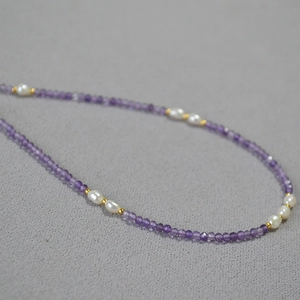 Close-up of lavender amethyst beads and freshwater pearls on an elegant thin necklace
