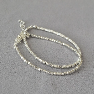 Detail of silver double-layered bracelet with crushed silver beads and adjustable lobster clasp