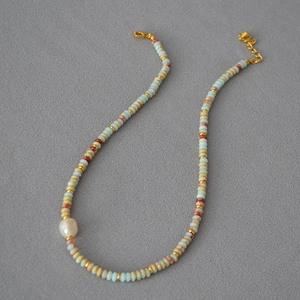 Exotic retro beaded necklace with blue stones and a baroque pearl pendant