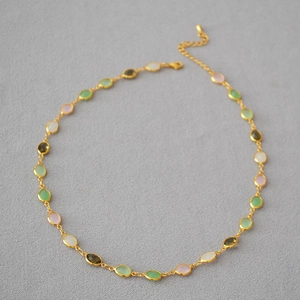 Detail of multi-color crystal glass necklace with gold-plated brass chain and lobster clasp