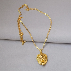 Hip-hop lion head pendant necklace with red gem eyes on a gold paperclip chain