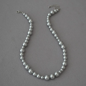 Detailed view of grey gradient pearl necklace with silver-tone lobster clasp and chain