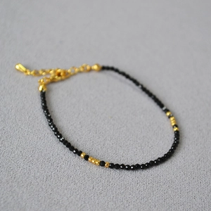 Minimalist faceted black spinel beaded bracelet with gold accents and extender chain