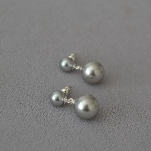 Detail of silver grey double pearl drop earrings with minimalist 925 silver needle design