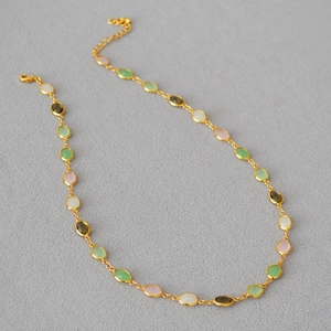 Detail of colorful faceted crystal gems with gold-plated brass chain and lobster clasp