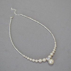 Elegant beaded necklace with high-luster pearls and sparkling silver accents in diagonal view