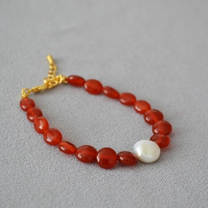 Détail du collier en perles d'agate rouge avec perle baroque et fermoir mousqueton doré