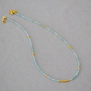 Minimalist aquamarine beaded necklace with gold accents and lobster clasp closure