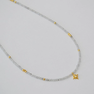 Minimalist grey moonstone beaded necklace with a sparkling gold star pendant