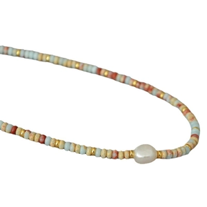 Bohemian beaded necklace featuring colorful stones and a baroque pearl centerpiece