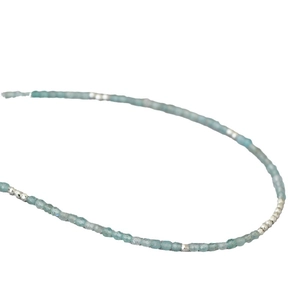 Minimalist aquamarine gemstone beaded necklace with silver spacers on white background
