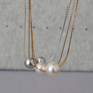 Minimalist pearl necklaces featuring gold and silver snake chains with varied pearl colors