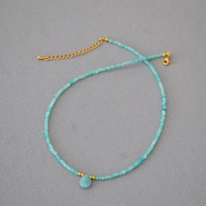 Minimalist turquoise beaded necklace with a water drop stone pendant and gold clasp