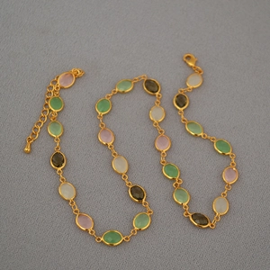 Detail of gold-plated brass necklace with multi-color faceted crystal glass gemstones