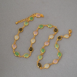 Detailed view of colorful faceted glass crystals set in gold-plated brass necklace links