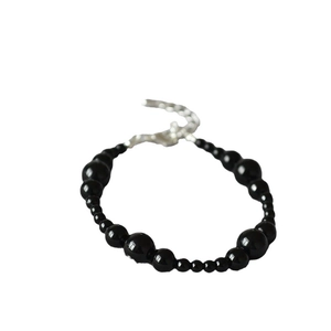Elegant black onyx beaded bracelet with gradient size beads and silver lobster clasp