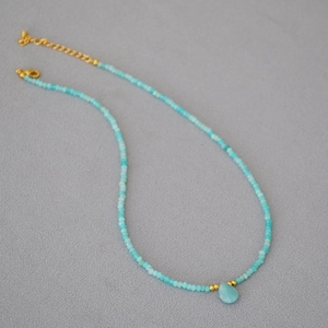 Minimalist turquoise beaded necklace with gold accents and teardrop stone pendant