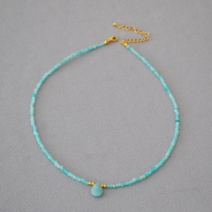 Detail of turquoise beaded necklace with water drop pendant and gold-plated lobster clasp